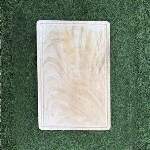 Organic single-block mango wood board styled with vegetables